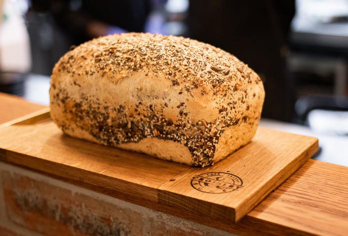 Seeded daily loaf on a Crossley-branded wooden board