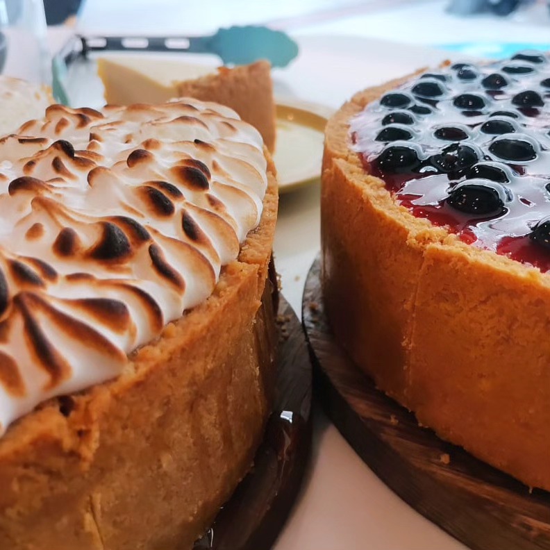 Two whole cheesecakes — lemon meringue and blueberry