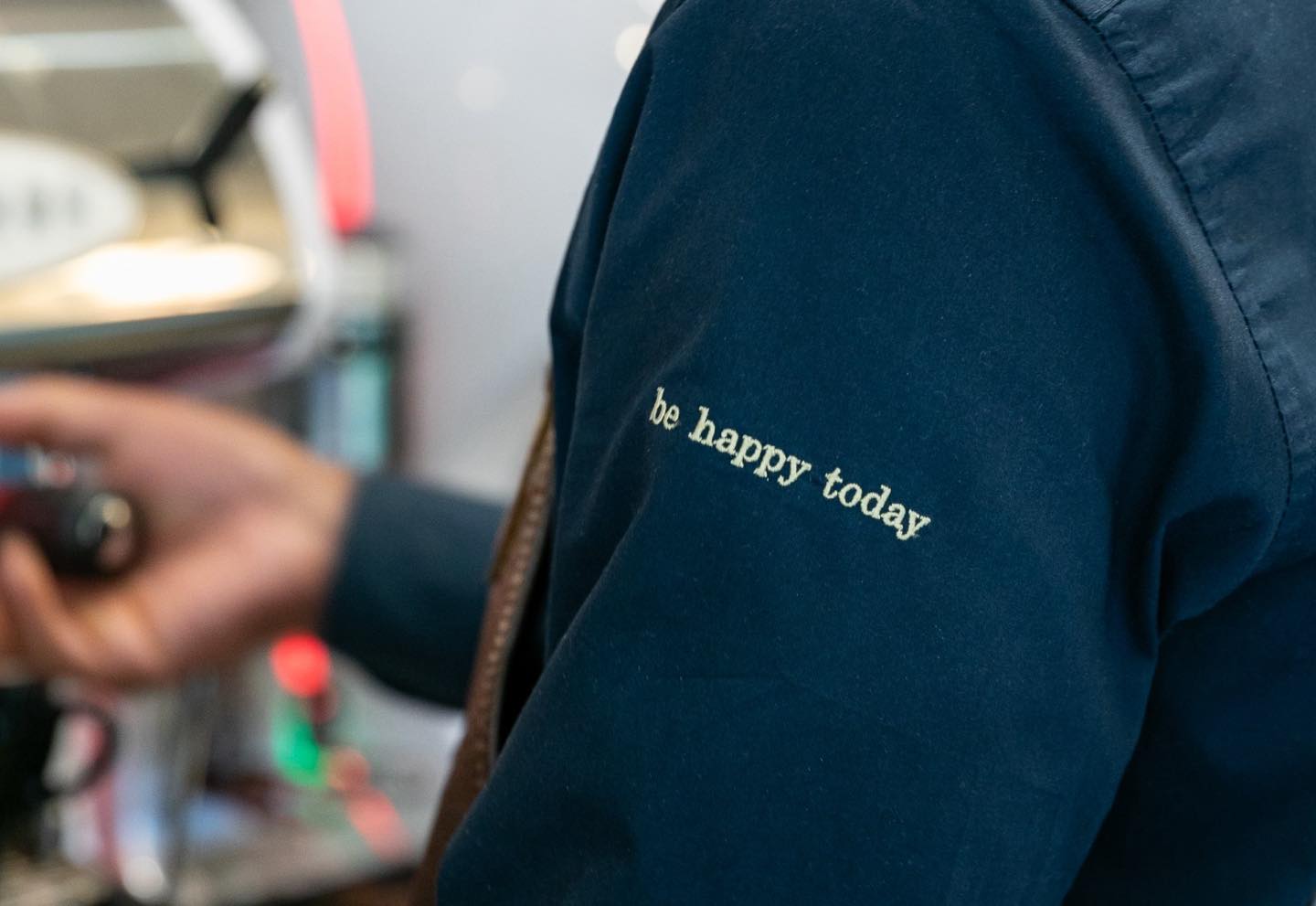 A Crossley uniform with 'be happy today' embroidered on the shoulder